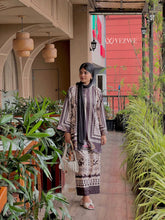 Woman wearing YEZWE modest ethnic co-ord set with printed long top and matching pants walking indoors